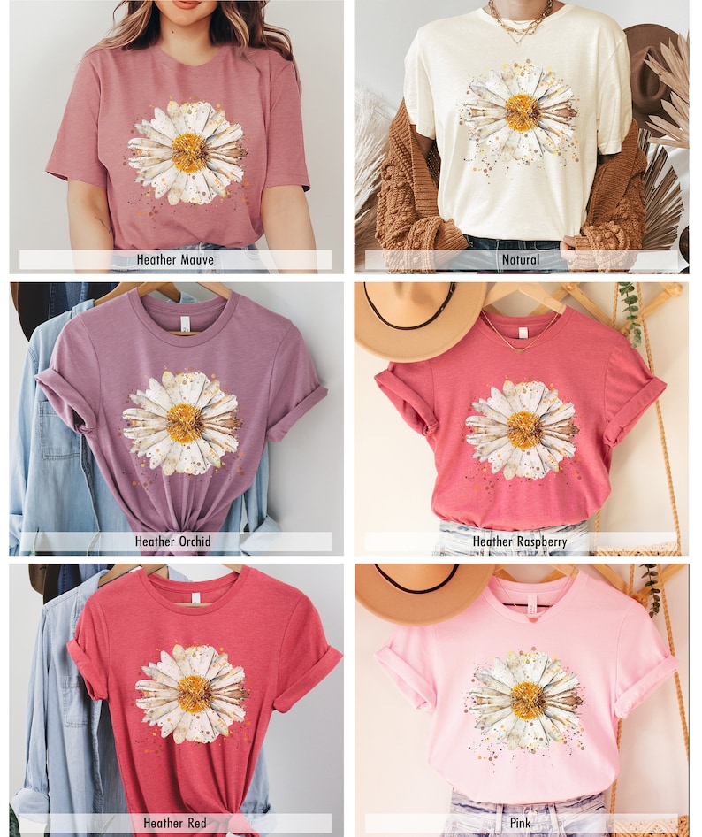 Pode incluir: Uma cole&ccedil;&atilde;o de seis t-shirts com um design de margarida em aquarela. As camisas est&atilde;o dispon&iacute;veis em Heather Mauve, Natural, Heather Orchid, Heather Raspberry, Heather Red e Rosa.