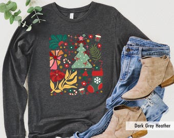 May include: Dark grey heather long-sleeved t-shirt with a colourful Christmas tree and floral design. The shirt has a crew neck and long sleeves.