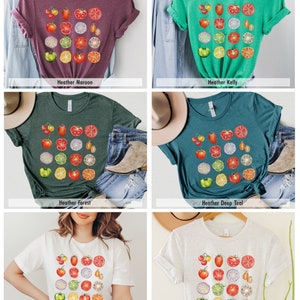May include: A set of six t-shirts featuring a colorful graphic of sliced tomatoes, onions, limes, and green peppers. The shirts are available in Heather Maroon, Heather Kelly, Heather Forest, Heather Deep Teal, White, and Ash.