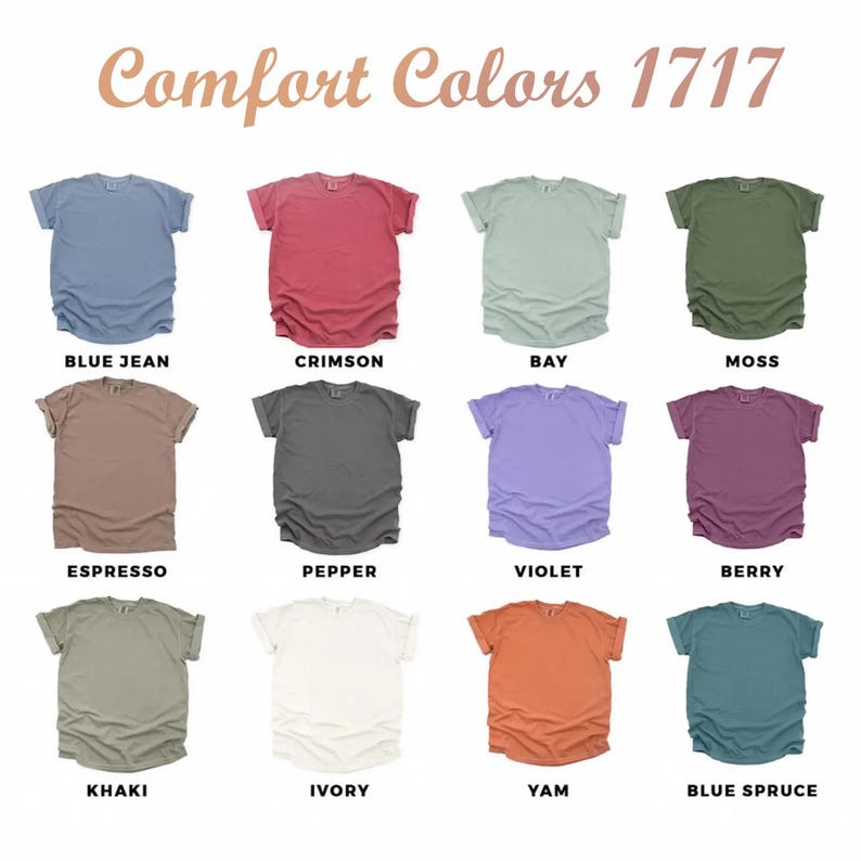 May include: A display of Comfort Colors 1717 t-shirts in various colors, including blue jean, crimson, bay, moss, espresso, pepper, violet, berry, khaki, ivory, yam, and blue spruce. The text "Comfort Colors 1717" is at the top.