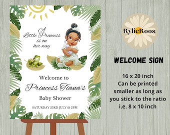 May include: A welcome sign for a baby shower with a green jungle theme. The sign features a cartoon image of Princess Tiana from Disney's The Princess and the Frog. The text reads "A Little Princess is on her way. Welcome to Princess Tiana's Baby Shower. Saturday 23rd July @ 2PM".
