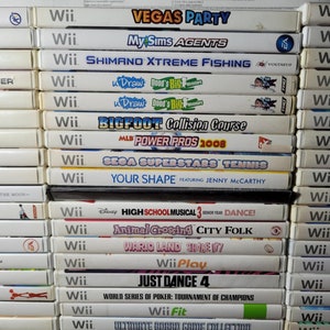 May include: A stack of 25 Nintendo Wii video game cartridges, including titles like "Vegas Party", "MySims Agents", "Shimano Xtreme Fishing", "Bigfoot Collision Course", "MLB Power Pros 2008", "Just Dance 4", and "Wii Fit".