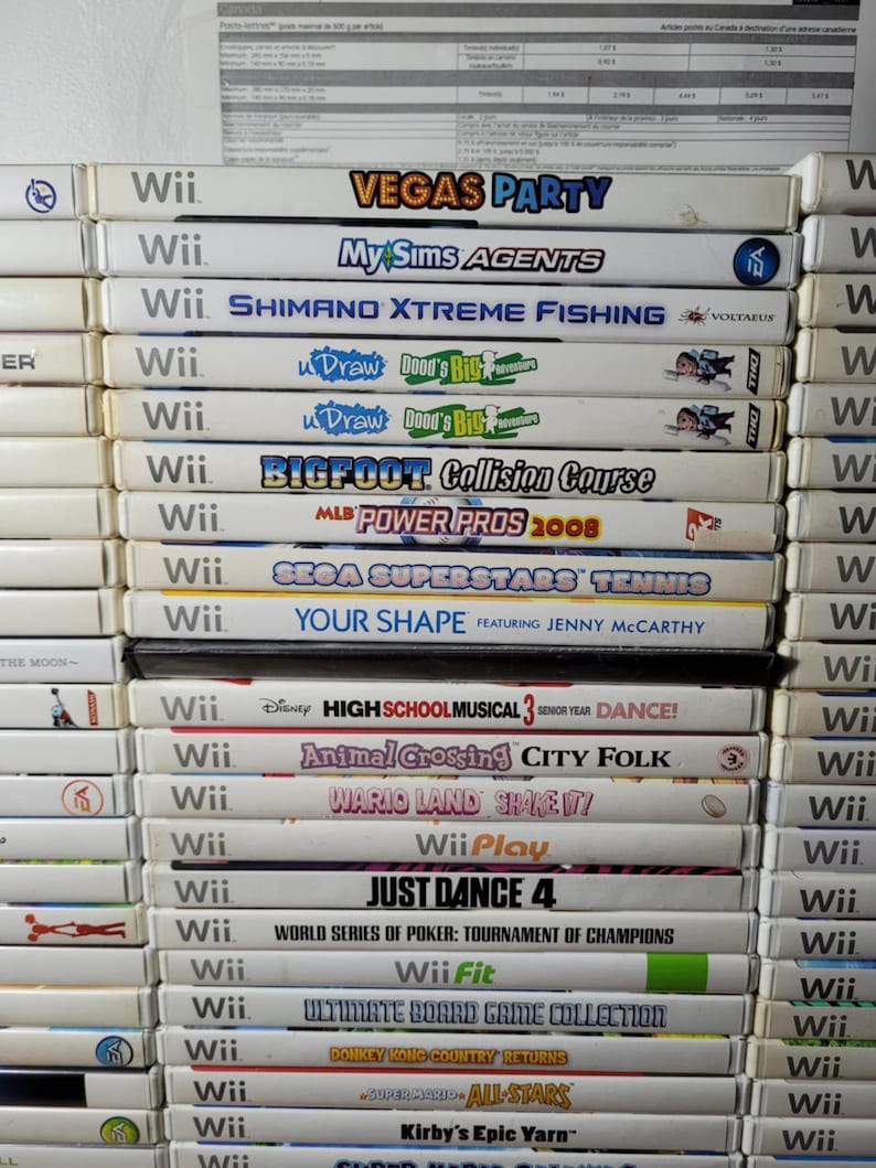 May include: A stack of 25 Nintendo Wii video game cartridges, including titles like "Vegas Party", "MySims Agents", "Shimano Xtreme Fishing", "Bigfoot Collision Course", "MLB Power Pros 2008", "Just Dance 4", and "Wii Fit".