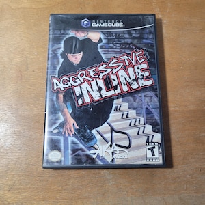 May include: A Nintendo GameCube video game case for "Aggressive Inline." The cover features a skater performing a trick on a rail, with graffiti art in the background. The game is rated "T" for Teen.