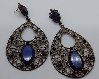 Jewerly, earings, teardrop peirced earings with blue gems and leafy filigree.