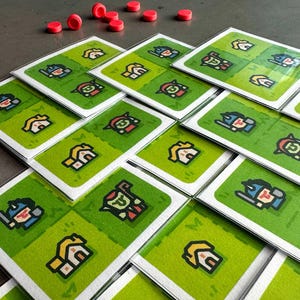 May include: A set of 16 game cards featuring illustrations of houses, warriors, and other characters. The cards are green with white borders and are stacked in a pile.