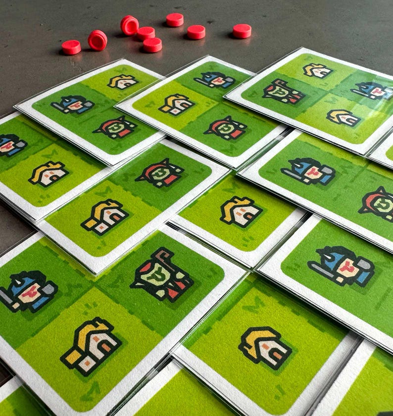 May include: A set of 16 game cards featuring illustrations of houses, warriors, and other characters. The cards are green with white borders and are stacked in a pile.