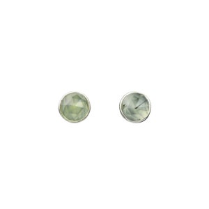May include: A pair of silver stud earrings with light green faceted gemstones.
