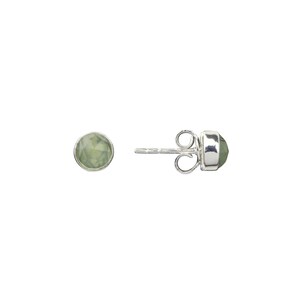 May include: A pair of silver stud earrings with a light green gemstone in each. The earrings have a post and butterfly back.
