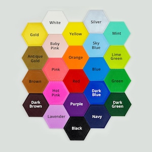 May include: A honeycomb-shaped chart with 19 hexagonal tiles, each a different color. The colors are: gold, white, antique gold, brown, dark brown, hot pink, lavender, black, purple, red, orange, yellow, baby pink, pink, sky blue, blue, dark blue, lime green, green, mint, and dark green.