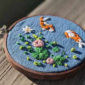 Handcrafted Embroidered Koi Pond with Beaded Details: Decorative 3D Embroidery Hoop with Blue Fabric, Seed Beads, and Embroidery Floss