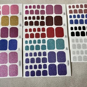 May include: Assortment of nail polish wraps in various colors and glitter finishes. Each sheet contains multiple sizes of nail wraps to fit different nail shapes and sizes.