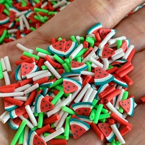 May include: A mix of red, green, and white polymer clay sprinkles. The sprinkles are shaped like watermelon slices and small sticks.