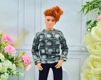 May include: A doll with red hair wearing a gray and black patterned long-sleeved shirt and dark blue jeans.