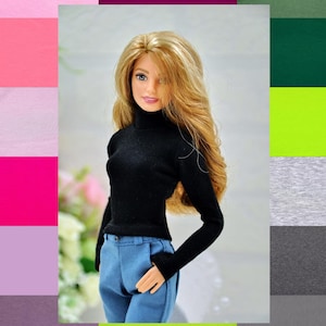 May include: A black mock neck shirt with long sleeves and a pair of blue jeans. The shirt is tucked into the jeans. The person is wearing a black mock neck shirt and blue jeans.