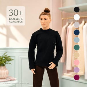 Può includere: Una bambola con un'acconciatura a chignon castano che indossa un maglione nero a maniche lunghe e pantaloni marrone scuro. L'immagine include il testo 30+ COLORS AVAILABLE e una colonna verticale di dieci cerchi colorati per varie opzioni.