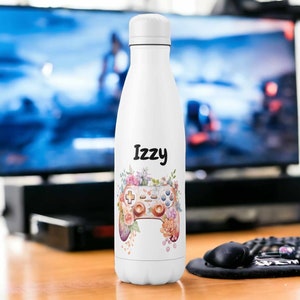 May include: White water bottle with a floral design and a video game controller. The name "Izzy" is printed on the bottle.
