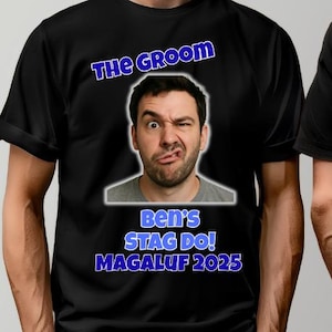 May include: Black t-shirt with the text "THE GROOM" in blue, above a photo of a man making a funny face. Below the photo, the text reads "Ben's STAG DO! MAGALUF 2025" in blue.