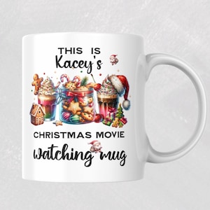 May include: White ceramic mug with a festive Christmas design. The mug features the text "THIS IS Kacey's CHRISTMAS MOVIE watching mug" and illustrations of gingerbread houses, cookies, and hot chocolate. A perfect gift for the holidays.