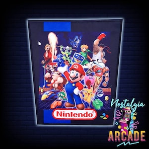 May include: A colorful graphic featuring various video game characters, including Mario, Donkey Kong, and Pikachu, with the Nintendo logo at the bottom. The image is framed with a black border and the words "Nostalgia Arcade".