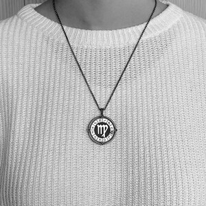 May include: A silver necklace with a circular pendant featuring the Virgo zodiac symbol and the astrological signs around the edge.