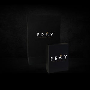 May include: Two black boxes with the logo "FREY Luxury Jewelry Design" printed in white with a gold diamond symbol.