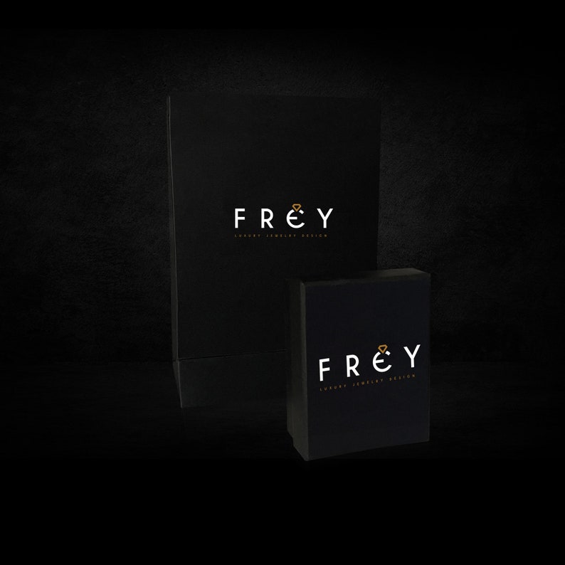 May include: Two black boxes with the logo "FREY Luxury Jewelry Design" printed in white with a gold diamond symbol.