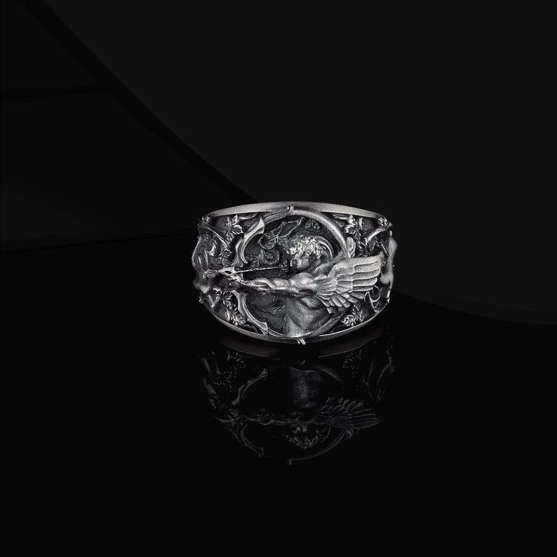 Embrace the eternal power of love and mythology with this Eros Angel Ring, meticulously handcrafted from 925 sterling silver.
Inspired by Eros (Cupid), the ancient symbol of desire, passion and divine attraction, this ring represents love that transcends time and fate.