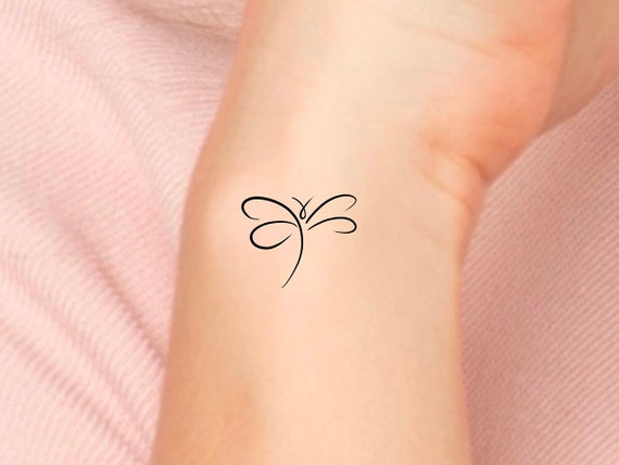 Tiny black dragonfly temporary tattoo get it here 