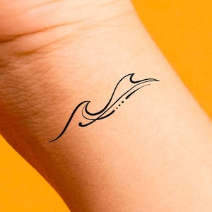May include: A simple black line drawing of a wave on a person's wrist.