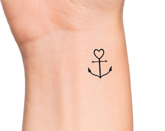 May include: A simple black line drawing of an anchor with a heart at the top. The tattoo is on a person's wrist.