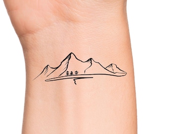 May include: A simple black line drawing of a mountain range with three small trees in the foreground. The image is on a light skin tone background.