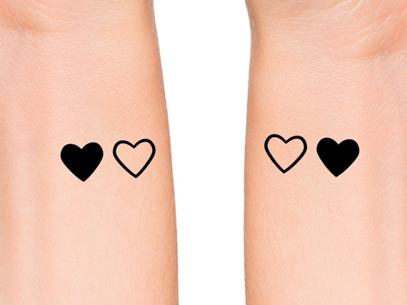 Mother and daughter matching heart tattoo placed on