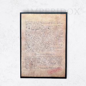 May include: A framed vintage document with handwritten text in a foreign language. The paper has a worn, aged appearance with a red "CONFIDENTIAL" stamp. The document is in a black frame.