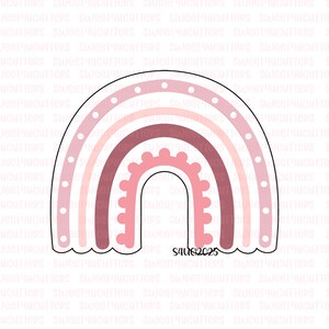 May include: A pink rainbow cookie cutter with a scalloped edge. The rainbow design features layers of pink and white, with a dotted pattern on the outer edge. The text "S4U62025" is at the bottom.