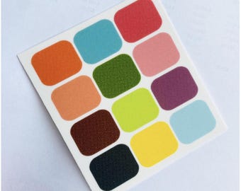 May include: A sheet of 12 colorful, textured, rounded square stickers. The stickers are in shades of orange, pink, green, brown, yellow, blue, and red.