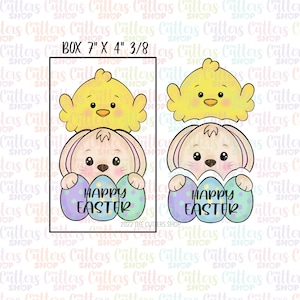 May include: An Easter-themed cookie cutter set featuring a chick and a bunny holding decorated eggs. The text "HAPPY EASTER" is displayed on the eggs. The box size is 7" x 4" 3/8. The design is in pastel colors.