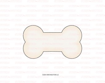 May include: A white bone-shaped cookie cutter with a light brown gradient effect. The cutter is designed for making dog bone-shaped cookies.