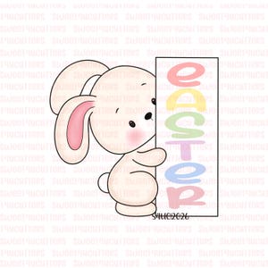 May include: A cookie cutter featuring a cartoon bunny holding a sign that says "EASTER" in pastel colors. The bunny is white with pink inner ears and a cute expression. A fun design for Easter-themed baking.