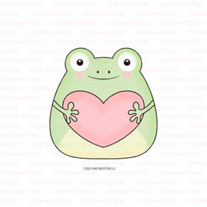 May include: A green frog with a big smile holds a pink heart in its hands. The frog is cartoon-like and has large eyes.