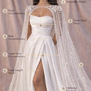 May include: A white strapless wedding dress with a high slit, paired with a sheer, beaded cape. The image highlights measurement points for shoulder width, bust circumference, and cape length, offering a detailed view of the bridal gown's design.