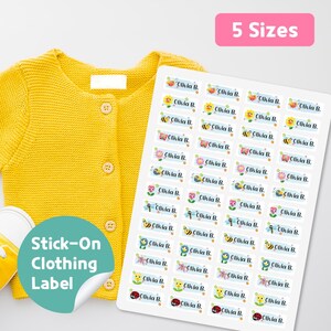 May include: A sheet of stick-on clothing labels with colorful illustrations of bees, flowers, and ladybugs. The labels are printed with the name "Olivia B." and are displayed next to a yellow cardigan. The text "5 Sizes" is visible.