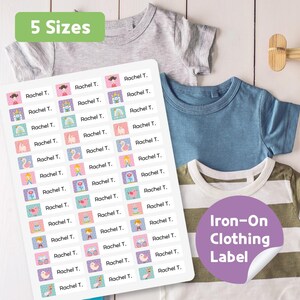 May include: A sheet of iron-on clothing labels with various colorful illustrations and the name "Rachel T." printed on each. The labels are displayed with several children's t-shirts. The image also includes the text "5 Sizes" and "Iron-On Clothing Label."