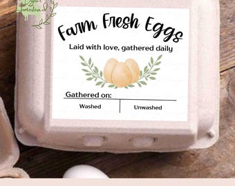 May include: Printable egg carton label with a white background and green leaves. The label says "Farm Fresh Eggs" and "Laid with love, gathered daily". There are three yellow eggs in the center of the label. The label also has a section for "Gathered on:" with checkboxes for "Washed" and "Unwashed".
