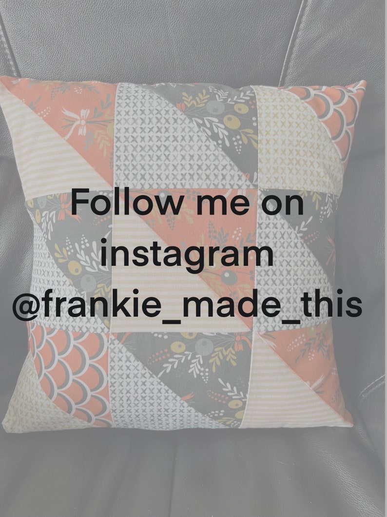 May include: A pillow with a patchwork design featuring geometric shapes and floral patterns in shades of orange, gray, and white. The pillow has the text "Follow me on instagram @frankie_made_this" printed on it.