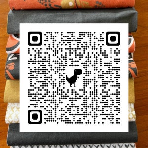 May include: A stack of fabric swatches in various patterns and colors, including orange floral, black and white geometric, and gold. A black and white QR code with a small black dinosaur icon is in the center of the image.