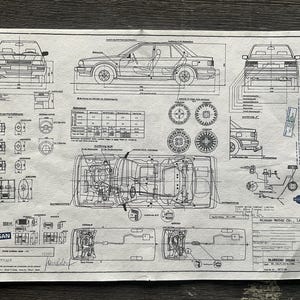 May include: A black and white technical drawing of a Nissan Bluebird, showing the car's dimensions, engine, and other technical details. The drawing includes text in English and Japanese.