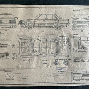 May include: A black and white technical drawing of a car, showing the side, front, top, and underside views. The drawing includes measurements and details of the car's design.