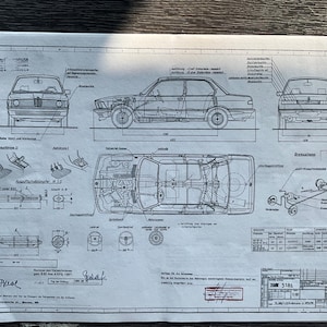 May include: A black and white technical drawing of a BMW 318i car. The drawing shows the car from different angles, including the front, side, and top views. The drawing also includes details of the car's engine, suspension, and interior.