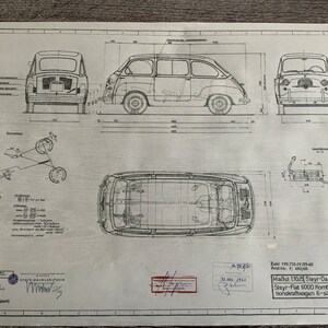 May include: A black and white technical drawing of a Fiat 6000 Kombina-tionskraftwagen 6-sitzig, a six-seater combination vehicle. The drawing includes front, side, and rear views of the vehicle, as well as a top view and a detailed diagram of the vehicle's suspension system. The drawing is labelled with the text "Steyr-Daimler-Puch A.G. SK8418" and "Maßst 1:10:15".